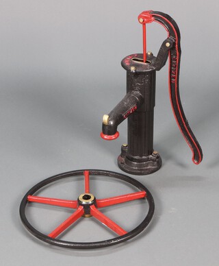 A reproduction "Citizen" black and red painted cast iron garden pump together with a 5 spoke wheel 47cm diam. 