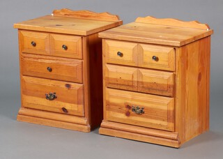 A pair of pine bedside chests of 3 drawers with raised backs, some handles missing 66cm h x 54cm w x 41cm d