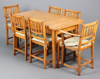 An Ercol light elm dining suite comprising rectangular draw leaf dining table raised on square tapered supports 73h x 104l x 70w and 6 stick and rail back dining chairs 