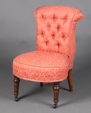 A Victorian mahogany nursing chair with scroll back, upholstered in pink buttoned material, raised on turned supports supports 68cm h x 47cm w x 40cm d 