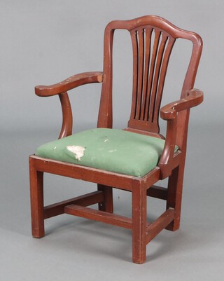 A child's Georgian style mahogany open arm carver chair with pierced vase shaped back, upholstered drop in seat, raised on square supports with H framed stretcher 61cm h x 47cm w x 31cm d.. The back with silver plaque marked "This chair is a copy from one owned by John Gurney of Eartham and was used by his children, given to his Great Granddaughter Alexander Buxton Christmas 1910"  