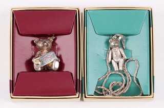A Steiff 925 silver pendant in the form of an articulated bear hung on a white metal chan together with a Steiff 925 silver brooch in the form of a bear holding a Steiff Club sign