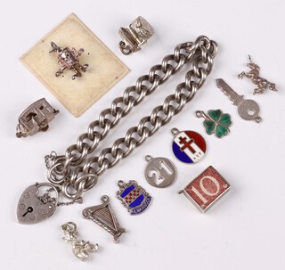 A silver curb link bracelet with padlock clasp 18cm, 53 grams together with 12 loose charms, 19 grams gross 