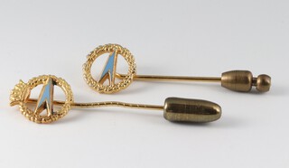 A 9ct gold and enamelled BOAC stick pin 1.3 grams gross and a gilt metal ditto 