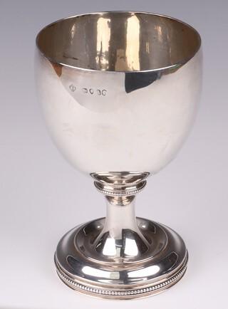 A Victorian silver goblet with bead work decoration on a spreading foot, London 1874 by George Angell & Co., 14cm, 210 grams 