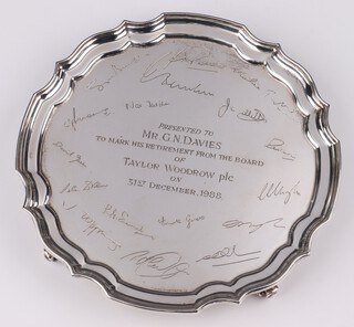 A silver salver with bracket border on scroll feet, with engraved signatures, Birmingham 1988 by J B Chatterley & Sons Ltd, 20cm, 344 grams 
