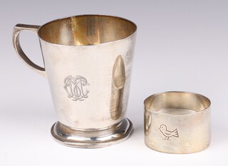 A silver christening tankard (dented and misshapen) London 1944, together with an engraved silver oval napkin ring London 1945, both by Wakeley & Wheeler, both are inscribed, 138 grams 