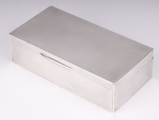 A rectangular silver cigarette box with engine turned decoration London 1919, makers mark CLS, 5cm h x 18cm w x 9cm d
