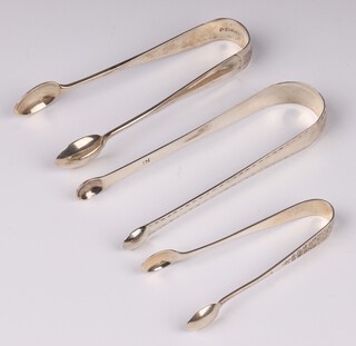 A pair of Georgian bright cut silver sugar tongs, marked Tepling, a pair of Victorian Old English pattern sugar tongs London 1885, pair of engraved silver sugar tongs Sheffield 1915, 80 grams 