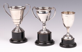 A silver goblet shaped trophy cup London 1932 (dented), a silver twin handled trophy cup Birmingham 1951, ditto Birmingham 1947, 155 grams gross including screws to base 