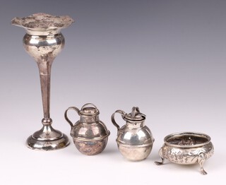 A Victorian embossed silver salt London 1880 by Harrison Brothers & Howson (no glass liner), an Edwardian novelty mustard pot in the form of a Jersey milk carrier Birmingham 1906, an Edwardian silver specimen vase in the form of a flower head Birmingham 1904 15cm and 1 other canister shaped mustard pot   