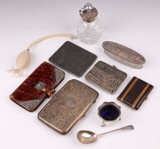 A silver salt with blue glass liner, a silver jam spoon, an engraved silver plated cigar case, crocodile and silver mounted purse, a cut glass perfume atomiser with silver collar and a oval cut dress dressing table jar with embossed silver lid   (some holes to lid)