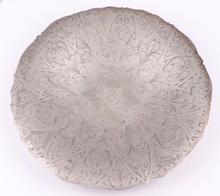 A circular Eastern engraved white metal floral bowl, raised on 3 panelled doors, the reverse marked A1000, 30cm diam.  