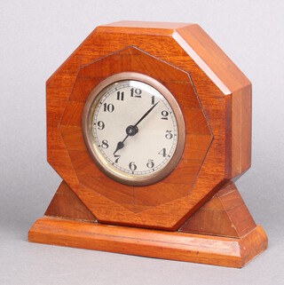 A 1930's Art Deco timepiece with 8cm silvered dial, Arabic numerals contained in an octagonal inlaid mahogany case 20cm h x 21cm w x 7cm d 