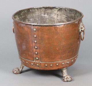 A circular copper copper with lion mask ring drop handles, raised on 3 paw feet 49cm h x 59cm diam. 