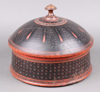 A circular Indian carved and painted wooden jar and cover 23cm h x 27cm diam.