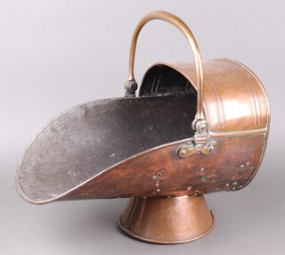 A Victorian copper helmet shaped coal scuttle raised on a circular spreading foot 33cm h x 44cm w (foot slightly misshapen) 