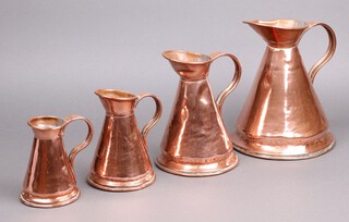 A set of 4 19th Century graduated copper jugs of waisted form 25cm, 19cm, 16cm and 14cm h