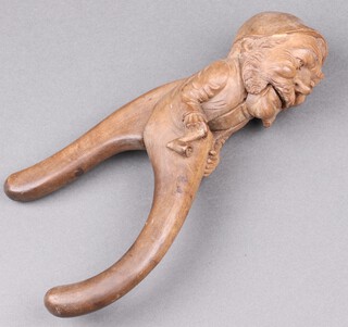 A pair of 19th Century Black Forest nut crackers in the form of gentleman with smoking cap and pipe 25cm 