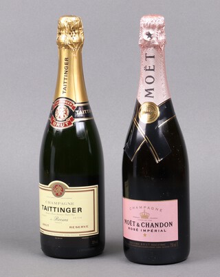 A bottle of Taittinger champagne and a bottle of Moet Rose Imperial champagne 
