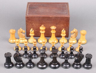 A turned black and white Staunton chess set, complete with wooden box 