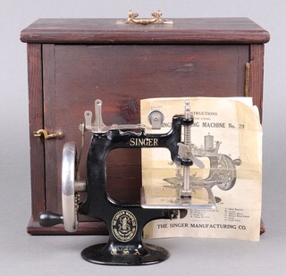 A child's Singer manual sewing machine no.20, complete with instructions, cased 