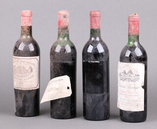 A bottle of 1953 Chateau Batailley Grand Cru Classe, bottle of 1974 Chateau Bertiquet St.St Emilion Grand Cru, bottle of 1986 Margaux (label loose) and a  bottle of 1990 Domaine du Grand Bosc Fitou, red wines 