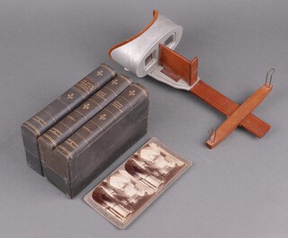 A stereoscopic slide viewer together with two boxes of slides - Studies through the stereoscope volumes 1 and 2 (33) and South African War (21)