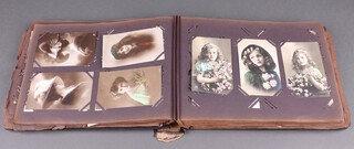 A postcard album containing approx. 276 black and white and coloured photographs including beauties 