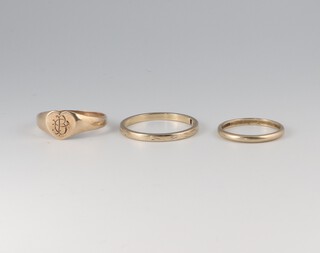 Two 9ct gold wedding bands and a gold signet ring marked 9ct, sizes R 1/2, J 1/2 and N 1/2, 5.4 grams