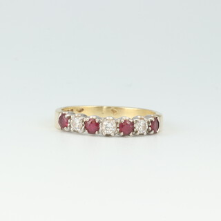 A gold marked 750 half eternity ring set 4 rubies and 3 diamonds, size L, 2.7 grams 