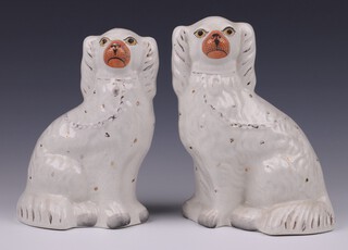 A near pair of 19th Century Staffordshire figures of seated Spaniels 23cm and 22cm 