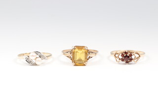A 9ct gold pearl and paste set ring size K, 1.3 grams, a 9ct gold and garnet set ring size M 1/2, 1.2 grams and a gold ring marked 9ct citrine set ring size Q 1/2, 2 grams