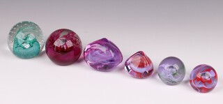 Six Caithness paperweights - Cauldron 6cm, Fire Ball 6cm, Pebble (x2) 5cm and Moon Crystal (x2) 3cm 