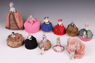 Eleven 1930's porcelain headed pin cushion dolls, some with legs