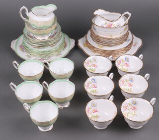 A 20 piece Royal Albert Prudence pattern tea service with circular bread plate, 6 tea plates, sugar bowl (cracked and chipped), milk jug, 5 cups (1 cracked), 6 saucers, together with a Royal Albert 21 piece Anemone pattern tea service comprising twin handled bread plate, 6 tea plates, sugar bowl, milk jug, 6 cups (1 cracked) and 6 saucers  