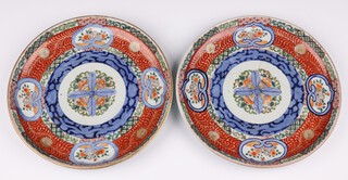 A pair of 19th Century Japanese Imari charges with panelled decoration 28cm 