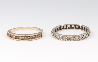 A 9ct gold ruby and diamond half eternity ring size P, 1.4 grams and a white metal paste set eternity ring size Q