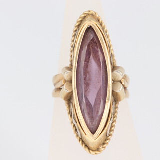 A gilt metal ring set an oval amethyst, marked 750 and 395A, size J,