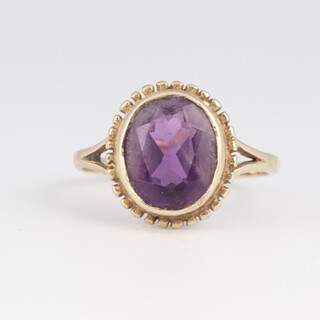 A 9ct gold and oval amethyst ring, size J 1/2, 2.4 grams  