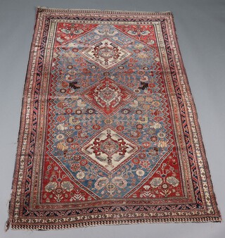 A blue and brown ground Caucasian rug with 3 diamonds to the centre within a multi row border, 207cm x 125cm 