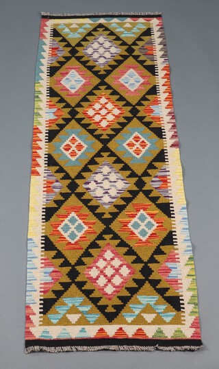 A green, black and orange ground Maimana Kilim runner with overall diamond design 195cm x 64cm 