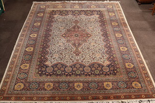 A white, blue and red ground machine made Persian style rug with central medallion within a multi row border 362cm x 276cm 