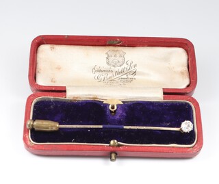 A diamond set tie pin, 2 grams and a gilt metal dress stud, with original box 