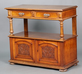 A Victorian bleached mahogany buffet supported by turned columns, the raised top fitted 2 drawers, the base enclosed by pair of carved, arched panelled doors, raised on bun feet 96cm h x 109cm w x 50cm d 