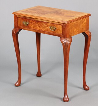 A Queen Anne style crossbanded walnut side table fitted a frieze drawer with brass swan neck drop handles, raised on cabriole supports 71cm h x 61cm w x 36cm d 