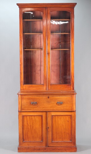 A Victorian mahogany secretaire bookcase, the upper section with moulded cornice, the interior fitted adjustable shelves enclosed by arch panelled doors, the base with secretaire drawer fitted pigeon holes and 2 short drawers, above double cupboard enclosed by pair of panelled doors 243cm h x 98cm w x 47cm d 
