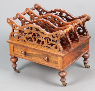 A Victorian rosewood 3 section Canterbury with pierced panels, the base fitted a drawer, raised on turned supports with brass caps and casters 46cm h x 56cm w x 40cm d 