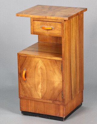An Art Deco walnut quarter veneered bedside cabinet fitted a drawer above recess with cupboard enclosed by a panelled door 75cm h x 40cm w x 36cm d 