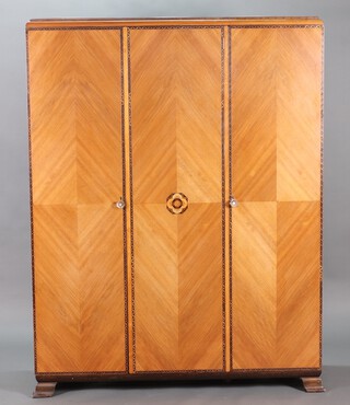 Gaylayde, a 1930's Art Deco inlaid figured walnut 5 piece bedroom suite comprising triple wardrobe, 1 section fitted 2 recesses and 2 trays, raised on bracket feet 189cm h x 146cm w x 50cm d, dressing table with hexagonal bevelled plate mirror above 1 long and 2 short drawers raised on square tapered supports 145cm h x  106cm w x 55cm d, rectangular dressing table stool with upholstered seat on square supports with H framed stretcher 44cm h x 75cm w x 41cm d, a tallboy fitted 4 drawers above cupboard enclosed by panelled doors with ivory handles raised on bracket feet 113cm h x 68cm w x 52cm d and a panel end bedstead 119cm h x 152cm w Ivory Exemption Certificate 2LNC4TWT